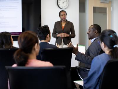 committee of people meeting in board room