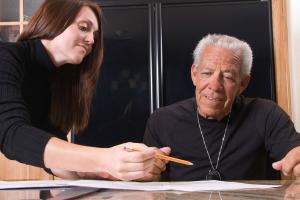 image of self-employed nurse with client in home