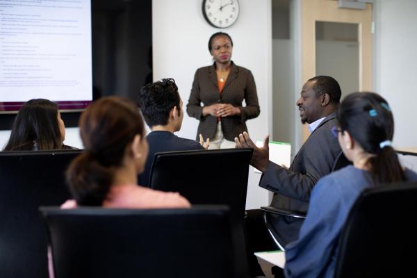 committee of people meeting in board room